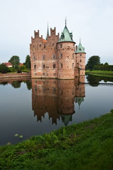 Egeskov castle slot landmark fairy tale castle in Funen Denmark vertical view