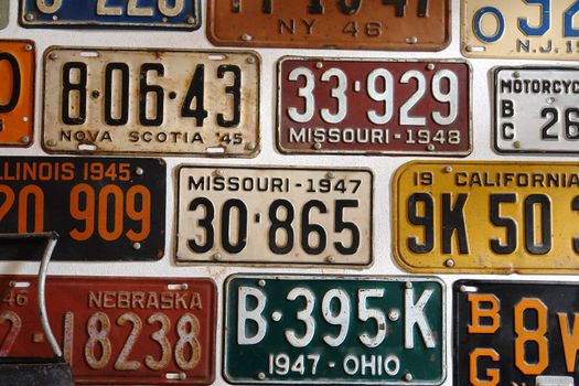 Vintage old days worn grungy rusty American cars number plates on display