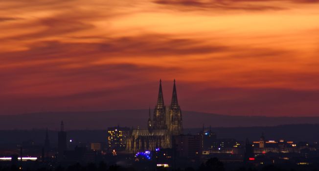 Skyline of Cologne at early evening, impressing colors in the clouds and sky