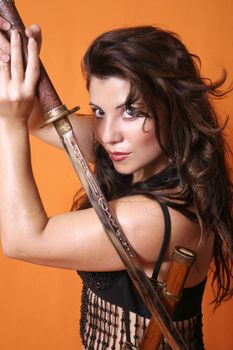 Brunette holding  a sword, the sheath over her shoulder