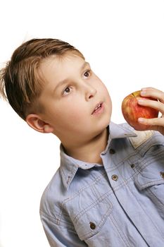 A young boy eating an apple