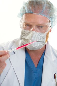Doctor or scientist holding a pipette.  Focus on man.