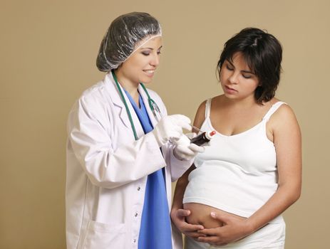 Nurse midwife or doctor  consults with a young pregnant woman