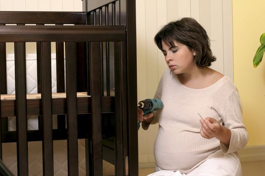 Young mother getting things ready for baby