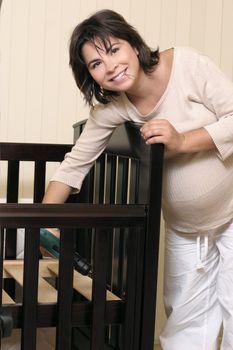 Mother to be screwing together baby bed