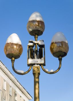 Street lamp shades covered with snow in Saratov