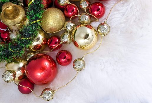 Elegant Christmas baubles with stars, angels and gold ribons on a slightly textured reflective surface