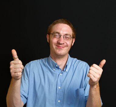 smiling young man with thumbs up 