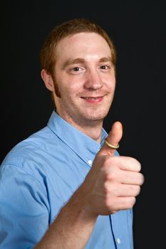 smiling young man with thumbs up 