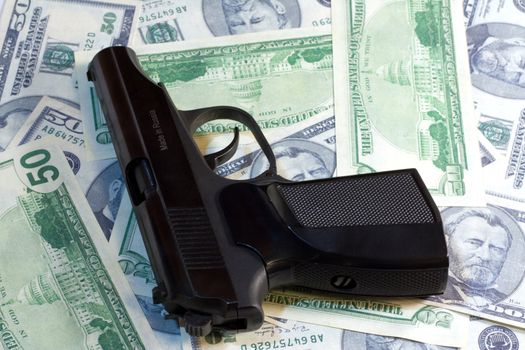 Russian Gun laying on a lot of American Dollars