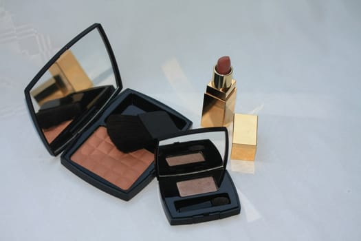 A blusher, an eyeshadow and lipstick, luxury makeup