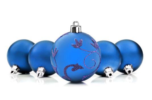 Blue christmas baubles on white background with space for text