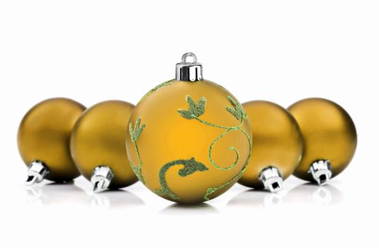 Golden christmas baubles on white background with space for text