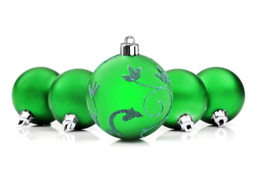 Green christmas baubles on white background with space for text