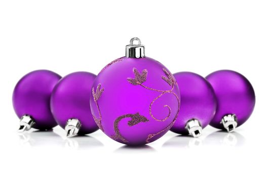 Purple christmas baubles on white background with space for text