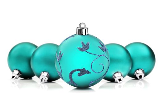 Blue christmas baubles on white background with space for text