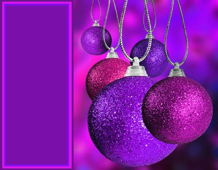 Close up of purple and pink christmas baulble balls in different sizes  hanging on strings