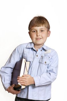 Boy holding some books  under his arm