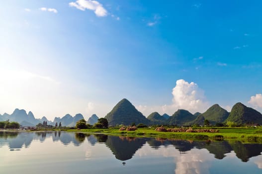 Reflection of the muntains in Li River landscape in morning light, Yangshuo near Guilin, 