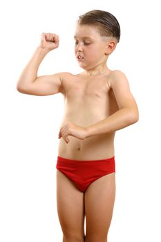 A young boy flexing muscles in his arm