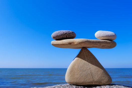 Symbol of the scales is made of pebble on the sea coast