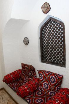 Part of traditional Uzbek interior with window and sofa