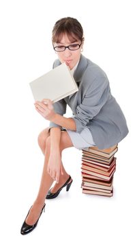 business woman  in spectacles and a pile of books