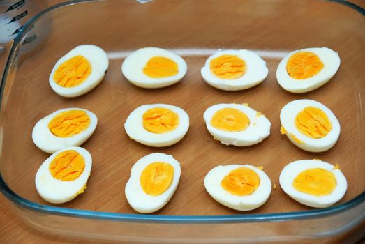 cut boiled eggs in glass dish in kitchen