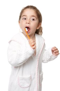 Young preschool age girl using a toothbrush to clean her teeth.