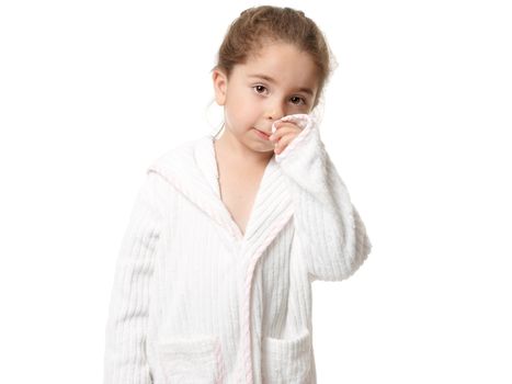 Pretty young girl standing in a white with pink trim bathrobe