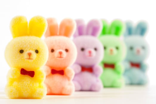 Colorful bunnies with bowties on white background.