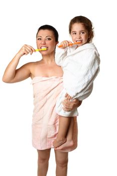 A mother and  her young daughter brushing their teeth .