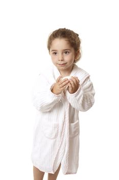 Little girl in bathrobe ready for bathtime, she is holding a bar of soap