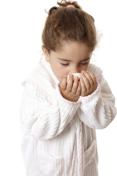 Young girl in bathrobe sniffing fragrant perfumed soap