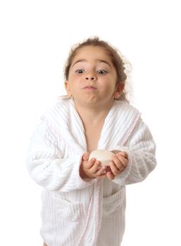 Young toddler girl in bathrobe holding soap wth character expression on a white background