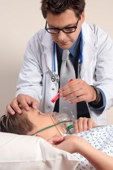 A doctor shining a light into a patient eyes checkup examination