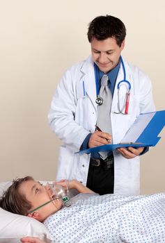 Caring cheerful doctor assesses a young patient's recovery.  No release required for ID badge and photo 