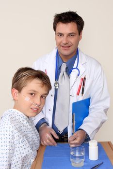 A doctor stands beside a young patient