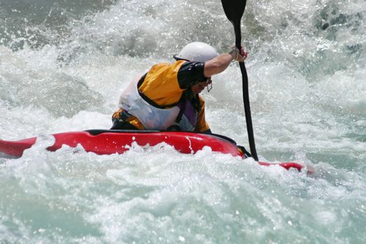 Extreme action - A kayaker battling strong rapids