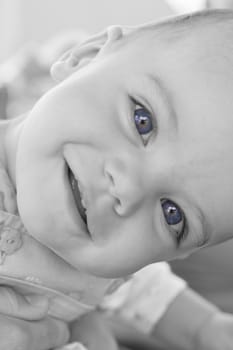 Happy baby girl with blue eyes