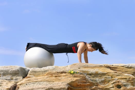 Pushups using pilates fitness ball