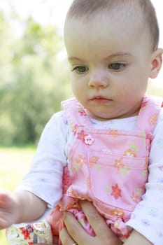 Thinking baby girl looking down