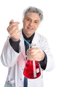 A smiling laboratory research worker adding a measured sample to a flask of solution.