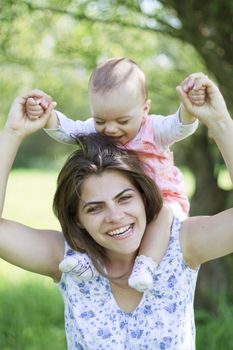 happy mother with her child on her shoulders