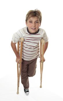 An injured child with sprained ankle using crutches.