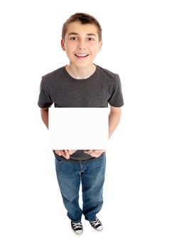 A pre teen boy holding a small blacnk sign, brochure or other item.
