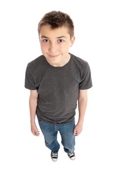 A friendly smiling boy standing in casual blue jeans and blank grey marle t-shirt.  Focus to face only with dof falloff.