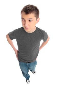 Boy in a grey t-shirt and blue jeans looking sideways