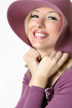 Friendly smiling woman holding a large brimmed hat