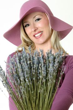 A female holding a bunch of dried lavender in her hands, 
